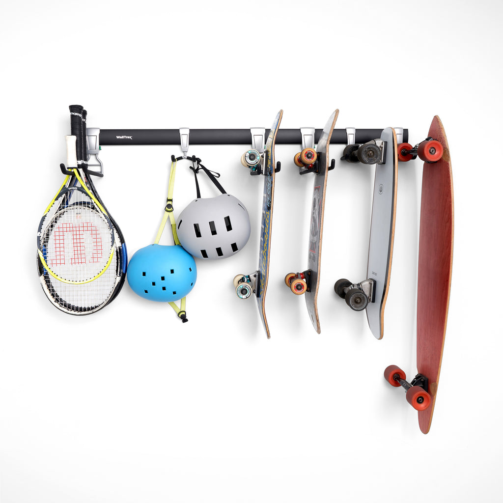 garage track system with adjustable hooks loaded with skateboards, and tennis rackets (7726746403030)