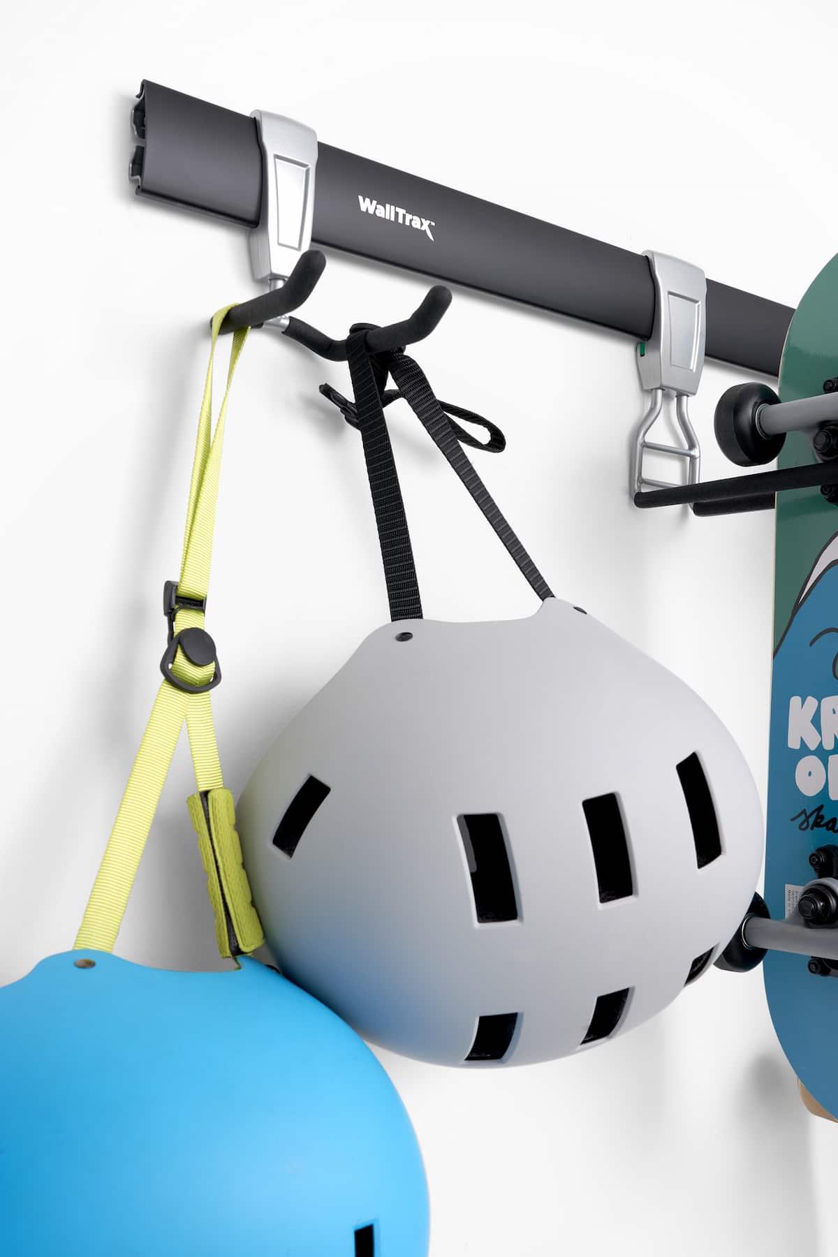 Close-up of wall rack holding two bicycle helmets