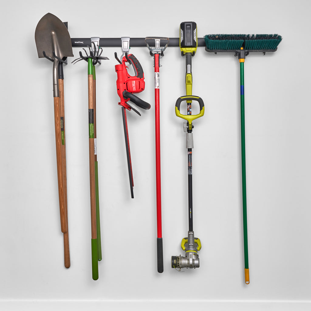 garage track system with adjustable hooks loaded with shovels, brooms, and gardening equipment (7726746403030)