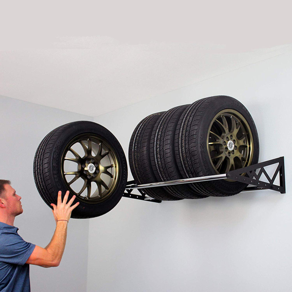 person loading tires on tire rack (7726746304726)