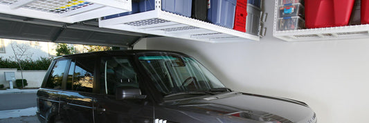 car parked inside of garage under ceiling storage racks