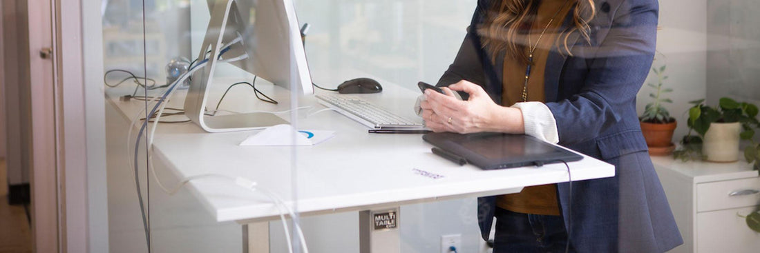 person using a standing desk at the office