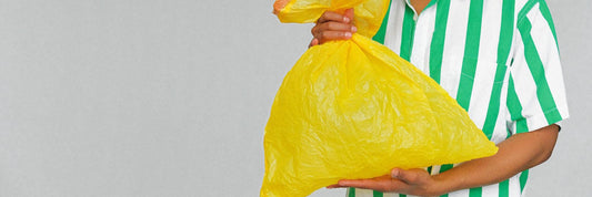 person holding trash bag