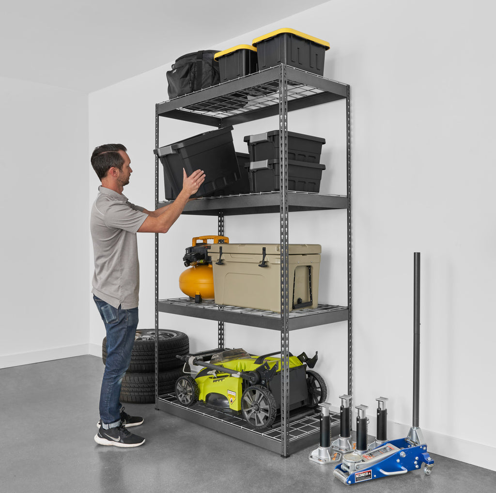 person removing a bin from a heavy duty garage shelving loaded with bins and garage tools