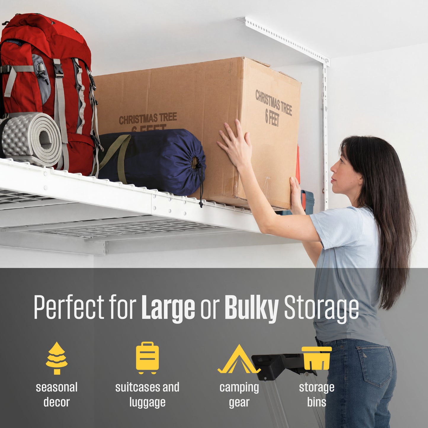 A woman pushes a large cardboard storage box onto a white overhead rack. A red backpack and other camping gear are visible on the rack, with text at the bottom reading 'Perfect for Large or Bulky Storage' and listing use cases like seasonal decor, suitcases and luggage, camping gear, and storage bins.