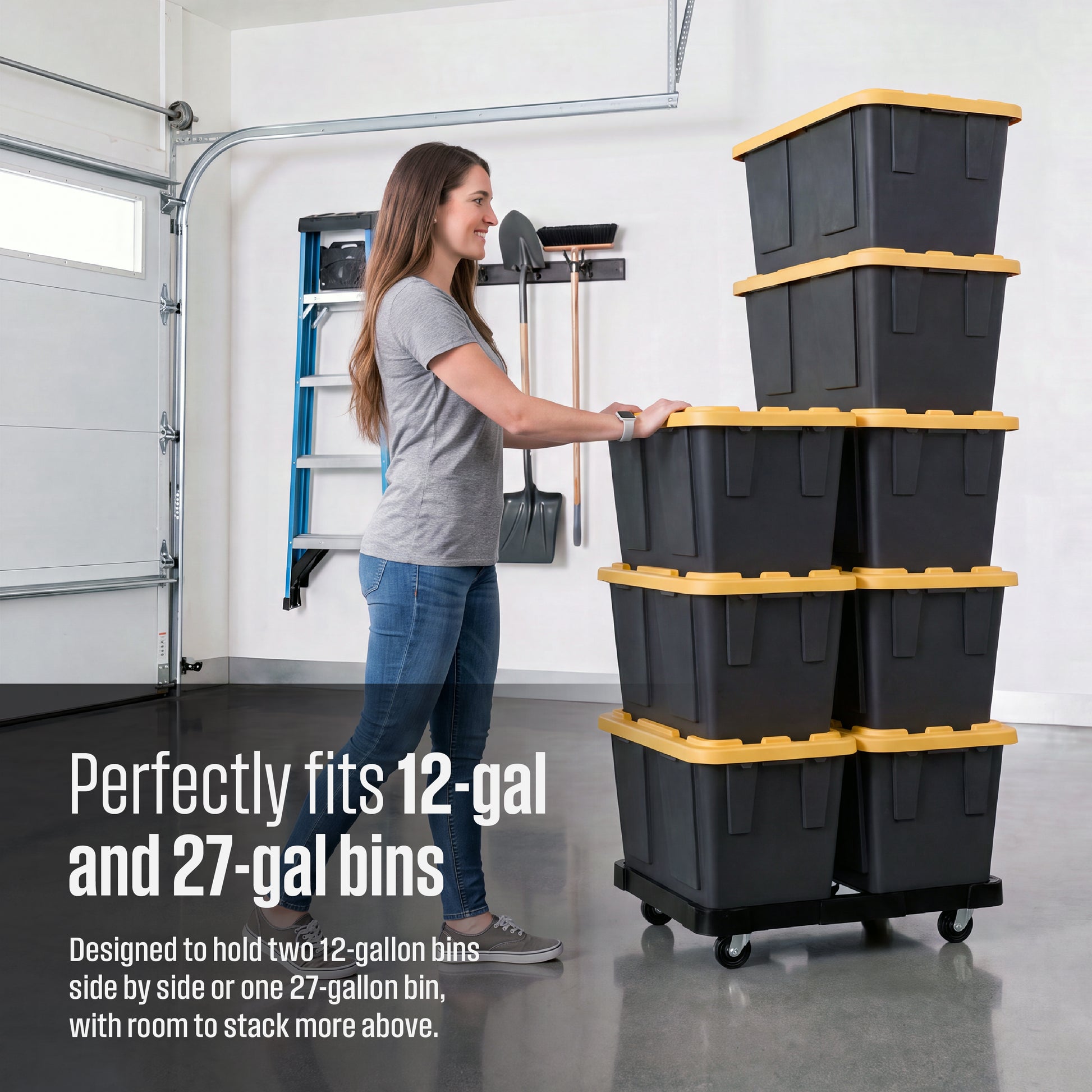 A woman in a gray t-shirt and blue jeans pushes a black plastic bin dolly stacked with eight 12-gallon plastic bins. Overlay text reads 'Perfectly fits 12-gal and 27-gal bins, designed to hold two 12-gallon bins side by side or one 27-gallon bin, with room to stack more above'