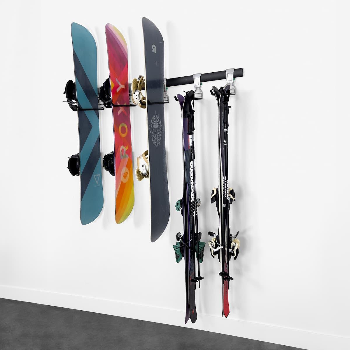 Wall rack holding three snowboards and two sets of skis