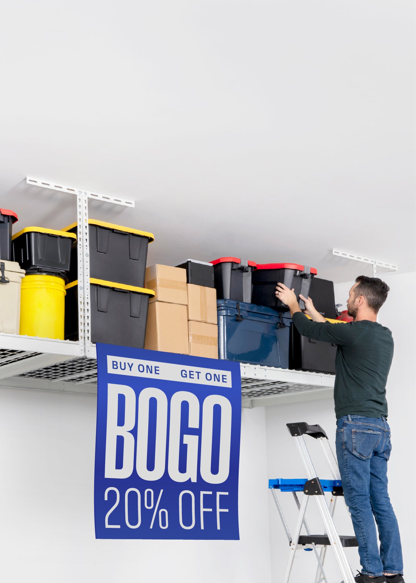 A man on a step ladder organizes storage bins on a white overhead rack. A large blue 'BOGO 20% OFF' sale sign hangs off the front of the overhead rack.