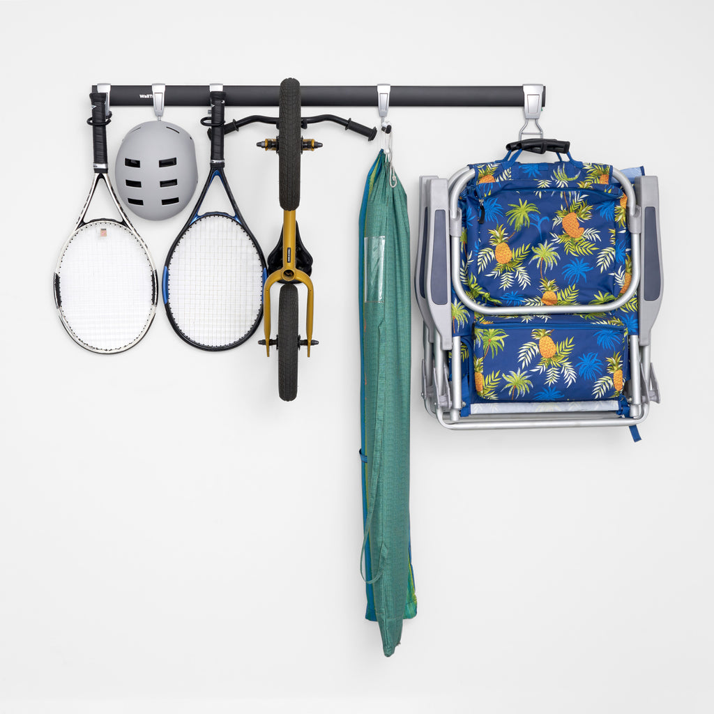 garage track system holding bicycle, helmet, tennis rackets, umbrella and brach chair