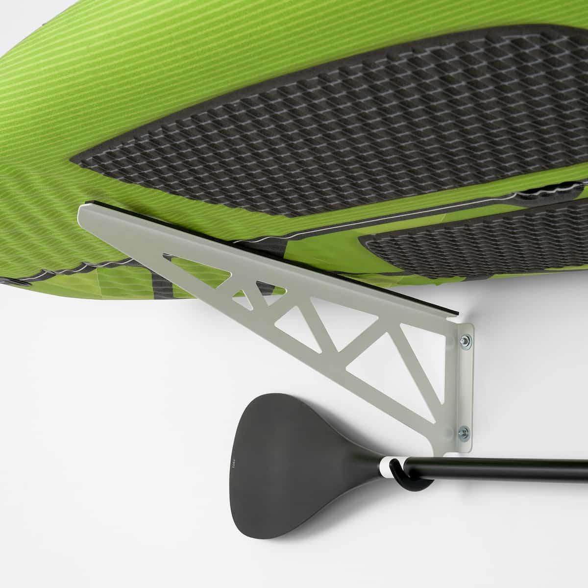 Close-up of oar and paddleboard on rack