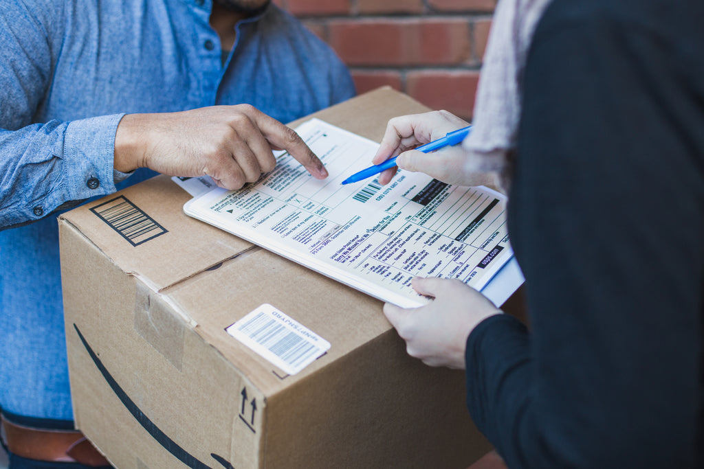 person receiving a package and signing a document 