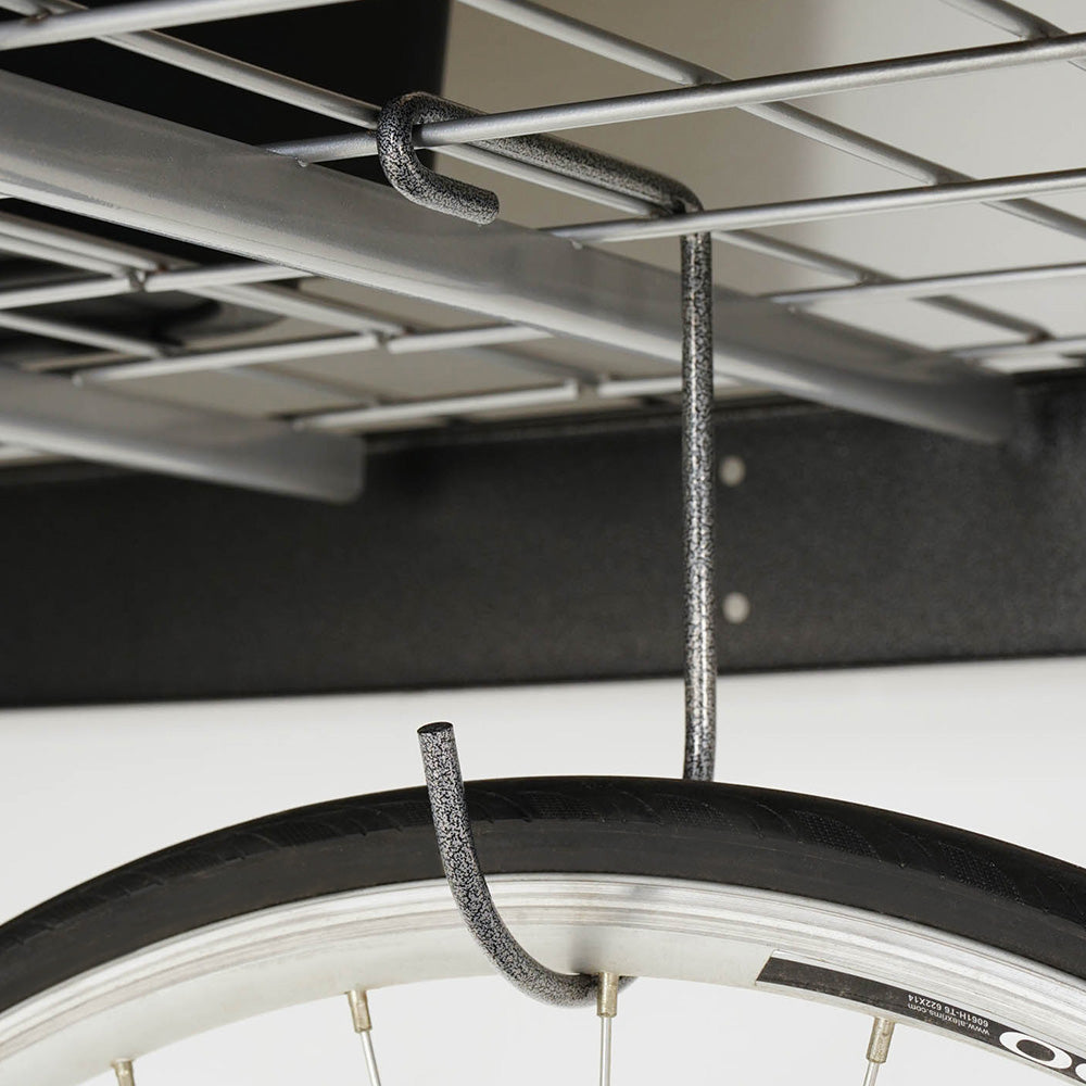 bicycle hanging from deck hook on overhead storage rack